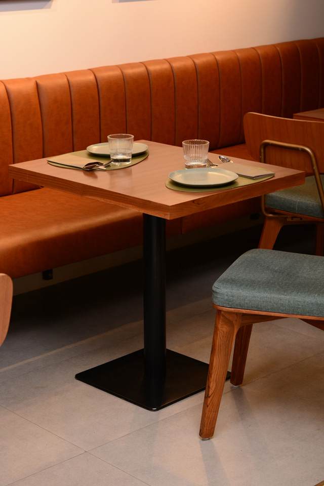 Lap and Dado Furniture for Plats Restaurant - Upholstered ribbed booth seating, teak veneer tables with single stand and custom made cafe chairs in teakwood