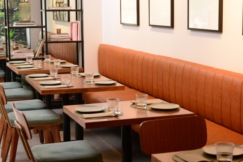 Lap and Dado Furniture for Plats Restaurant - Upholstered ribbed booth seating, teak veneer tables with single stand and custom made cafe chairs