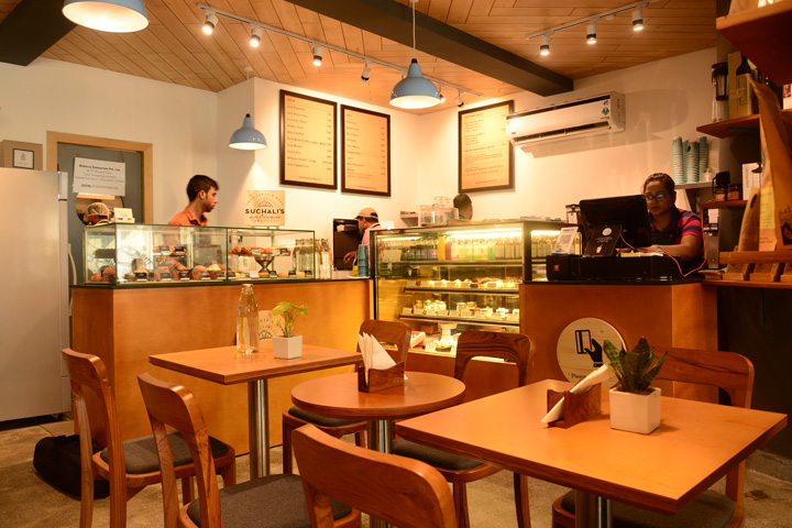 Lap and Dado Furniture for Blue Tokai Coffee - Cafe tables in birch ply with single stand legs and teak wood chairs, cafe counter with glass display and shelving