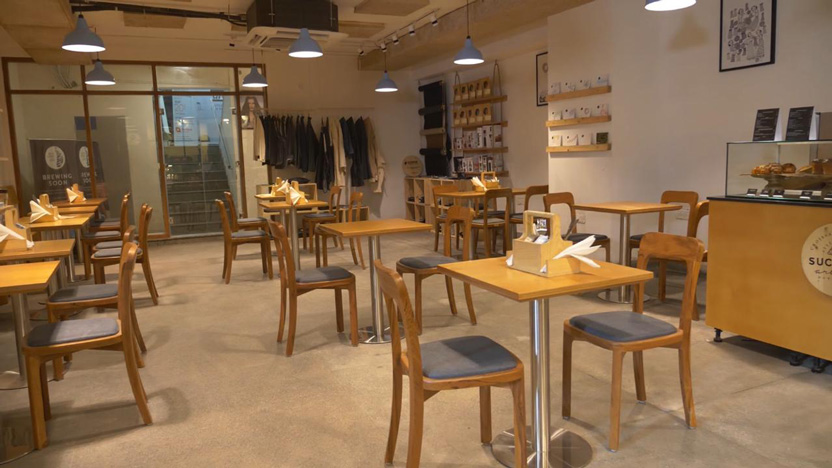 Lap and Dado Furniture for Blue Tokai Coffee - Cafe tables in birch ply with single stand legs and teak wood chairs, Cafe counter and glass display for Suchali Artisan Bakehouse