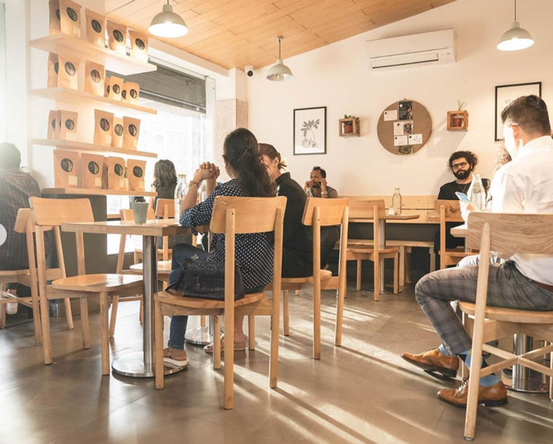 Lap and Dado Furniture for Blue Tokai Coffee - Cafe tables in birch ply with single stand legs and ash wood chairs